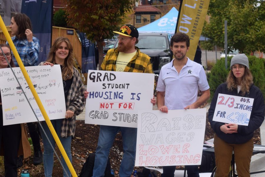 Graduate student protestors holding up signs at the corner of 20th and Broadway, as photographed on Oct. 26, 2022.