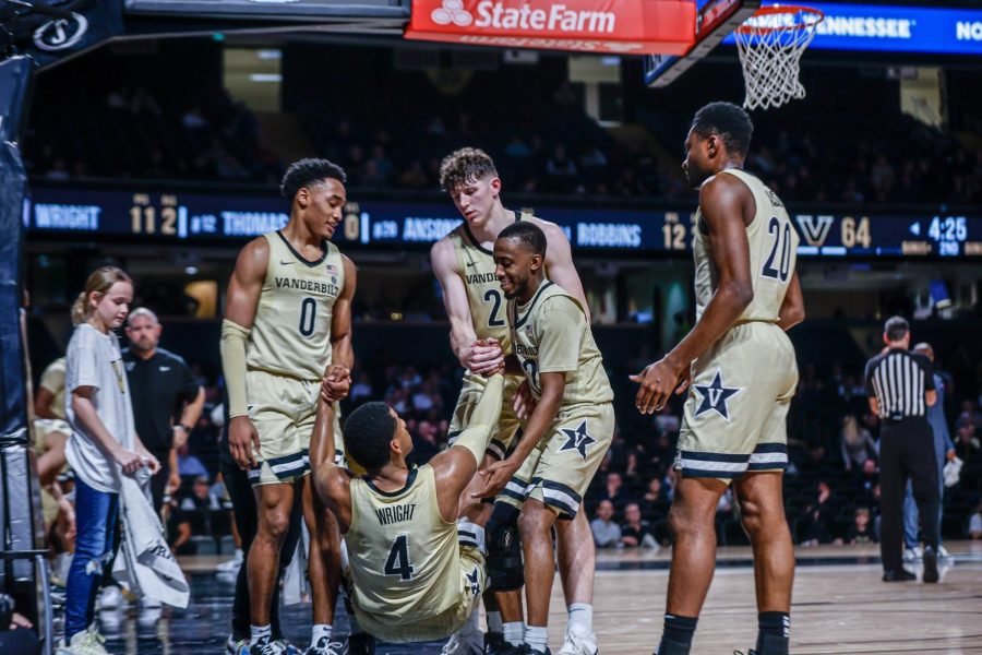 Jordan Wright helped up by a slew of teammates versus Pittsburgh on Dec. 7, 2022. (Hustler Multimedia/Josh Rehders)