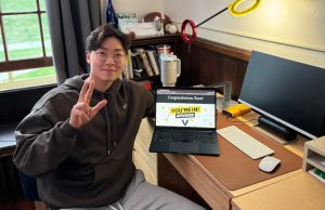 Newly admitted student Ryan Ryu poses with his acceptance letter from Vanderbilt. (Photo courtesy of Ryan Ryu)