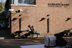 Students sit outside of Rand Hall, as photographed on April 9, 2025. (Hustler Multimedia/Abbie Bobeck)